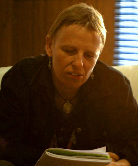 Poet Jackson reading from their notebook