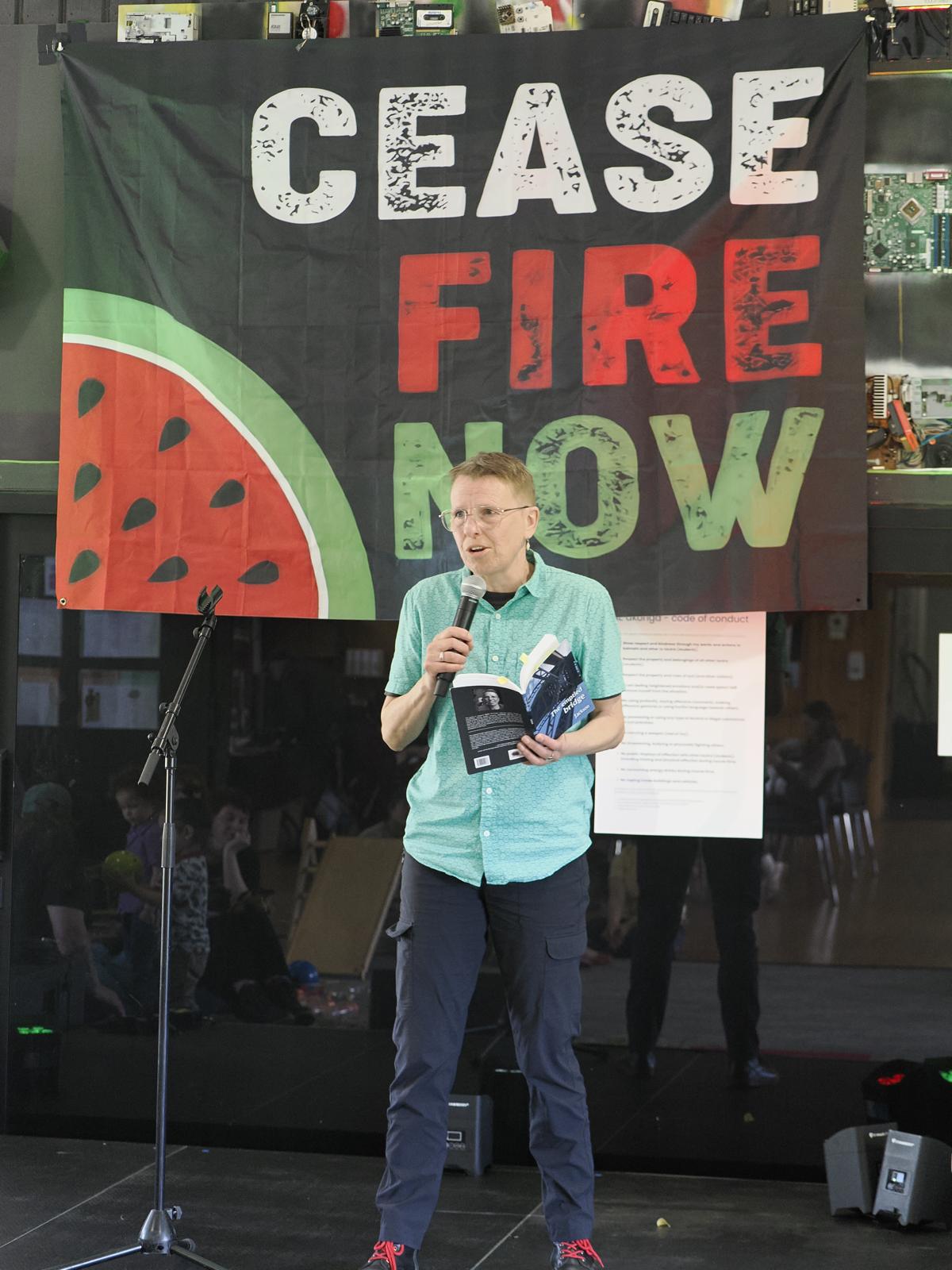 Poet Jackson reading at a fundraiser for Palestinian refugees and families, Ōtepoti Dunedin 2025